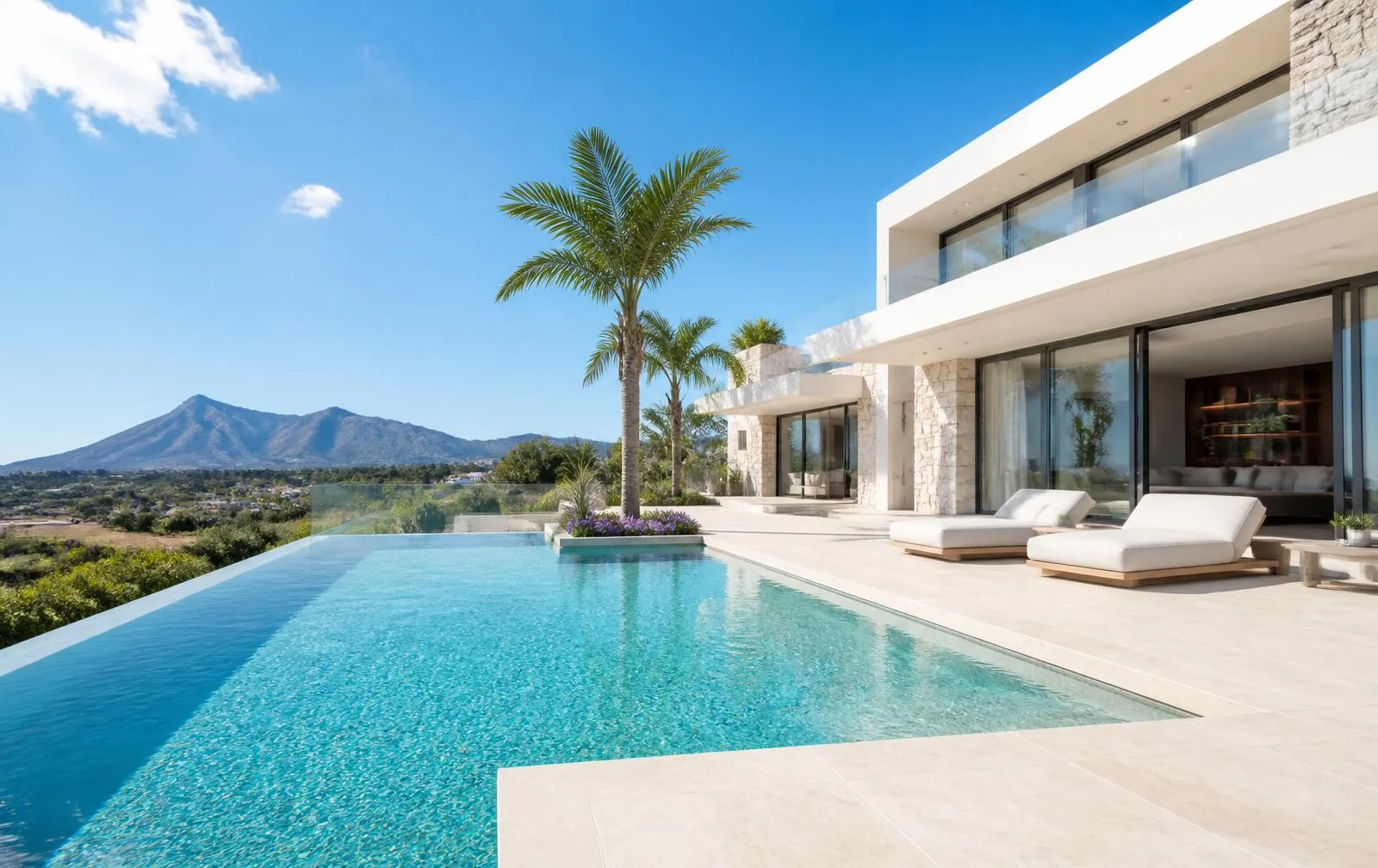 Luxury villa with infinity pool overlooking the mountains at sunset